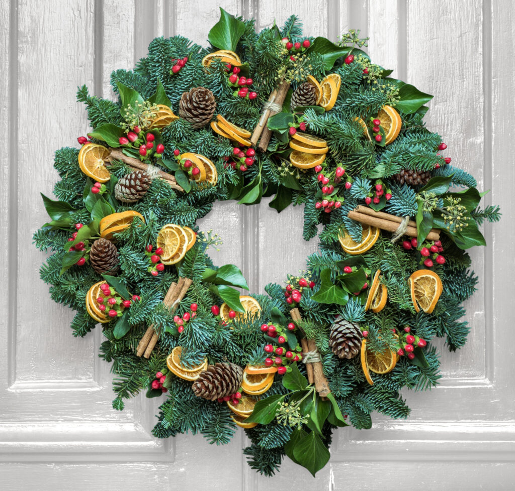 Christmas Wreath Workshop Door Wreath Wreath made with a variety of greenery on a grey door