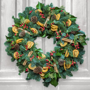 Christmas Wreath Workshop Door Wreath Wreath made with a variety of greenery on a grey door